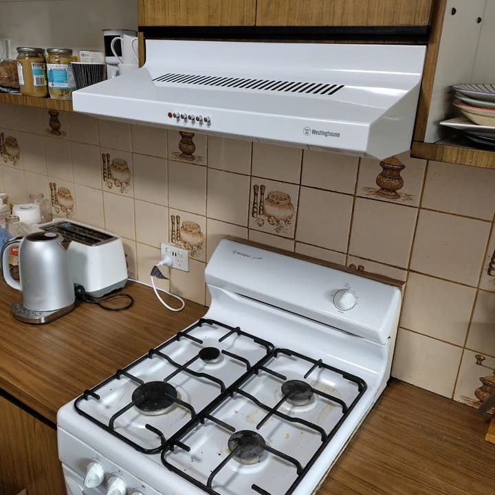 New rangehood installed and wired above the cooktop.