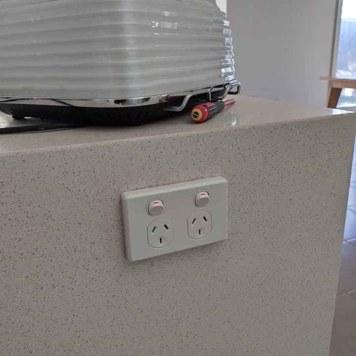 Double power point set flush into a stone benchtop run.