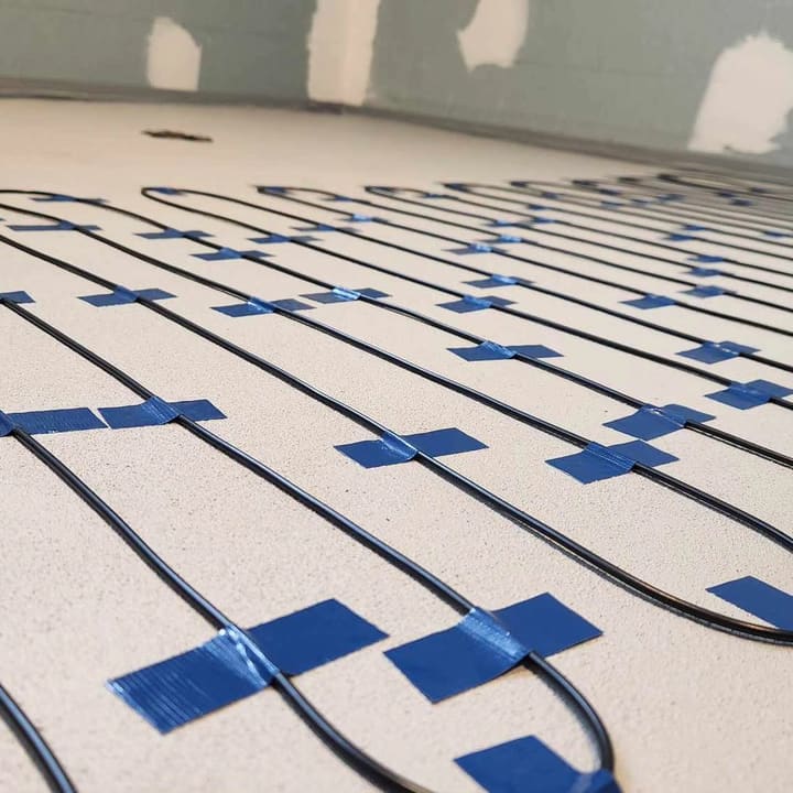 In-slab heating cable set out and taped down ahead of the floor pour.